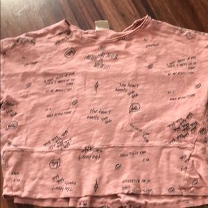 Pink shirt with black text